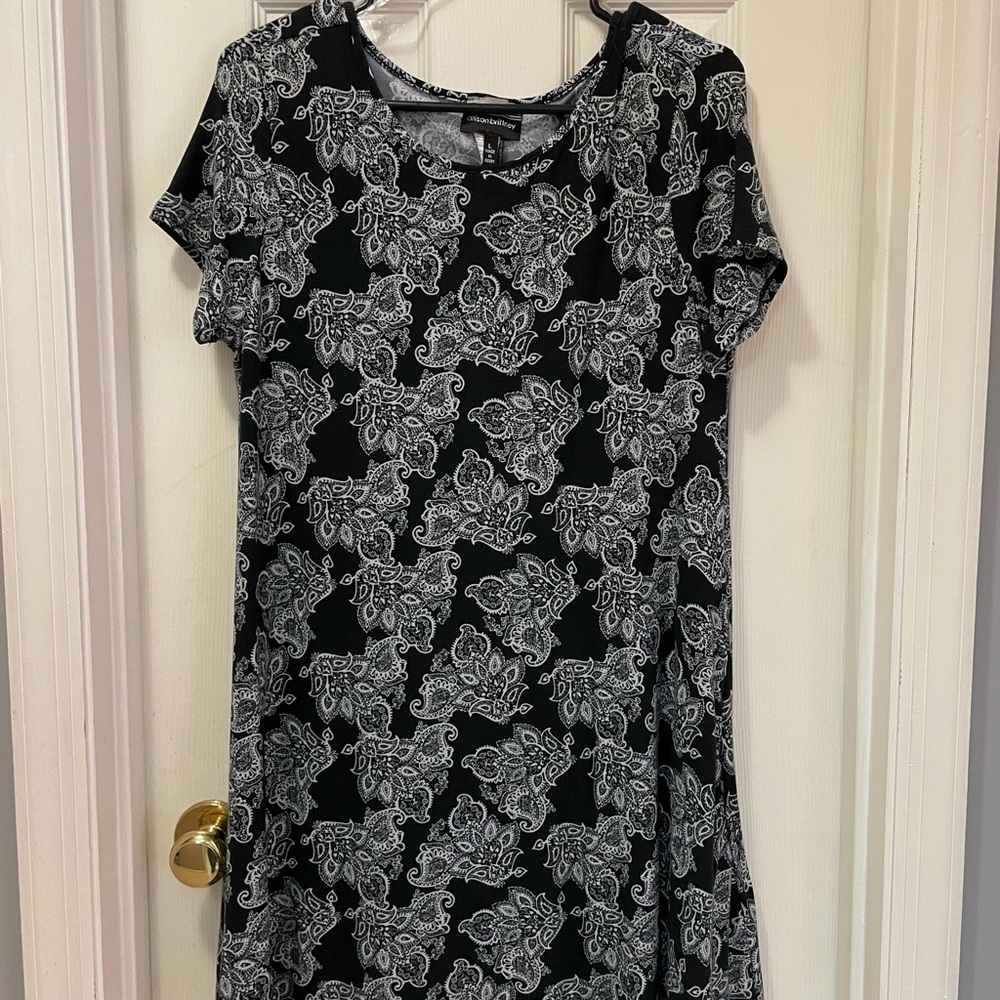 Black tee shirt dress with all over white paisley design. Short sleeves.